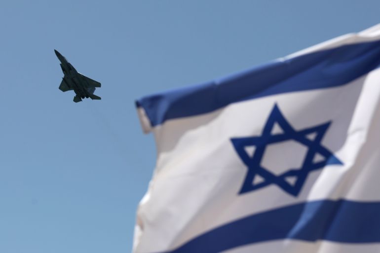 a plan flies near an Israeli flag