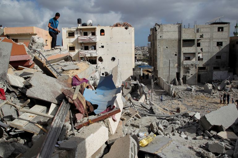 A Palestinian boy stands on top of rubble as he inspects the site of an Israeli strike on a house, amid the ongoing conflict between Israel and Hamas, in Rafah, in the southern Gaza Strip May 5, 2024. REUTERS/Hatem Khaled