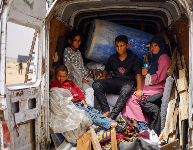 Displaced Palestinians of Salman family ride in a vehicle loaded with their belongings as they prepare to flee Rafah following a nearby Israeli strike on an area designated for displaced, in Rafah in the southern Gaza Strip, May 27, 2024. REUTERS/Mohammed Salem