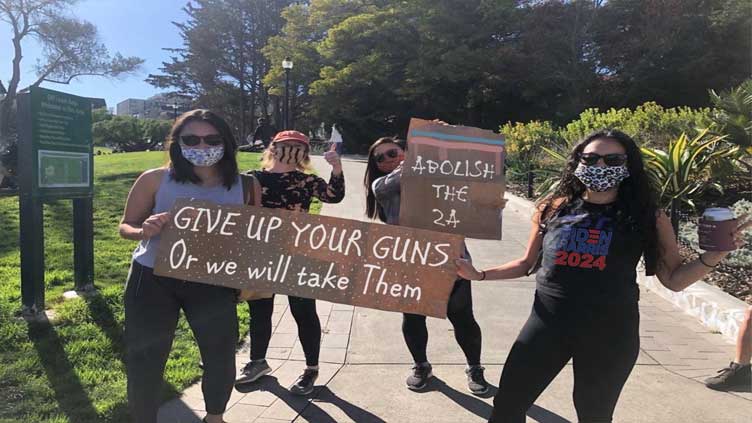 Image of women with gun control posters is altered