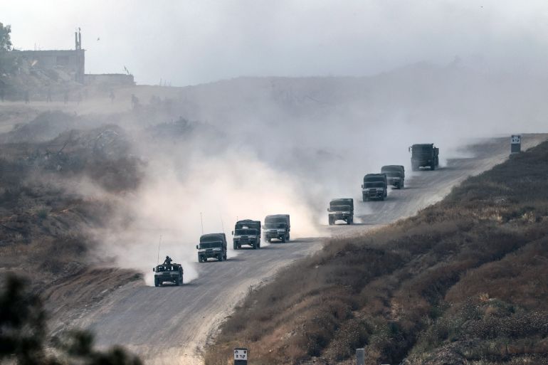This picture taken from Israel's southern border with the Gaza Strip shows Israeli military vehicles returning from the Palestinian territory on May 1, 2024, amid the ongoing conflict between Israel and the militant group Hamas. (Photo by JACK GUEZ / AFP)