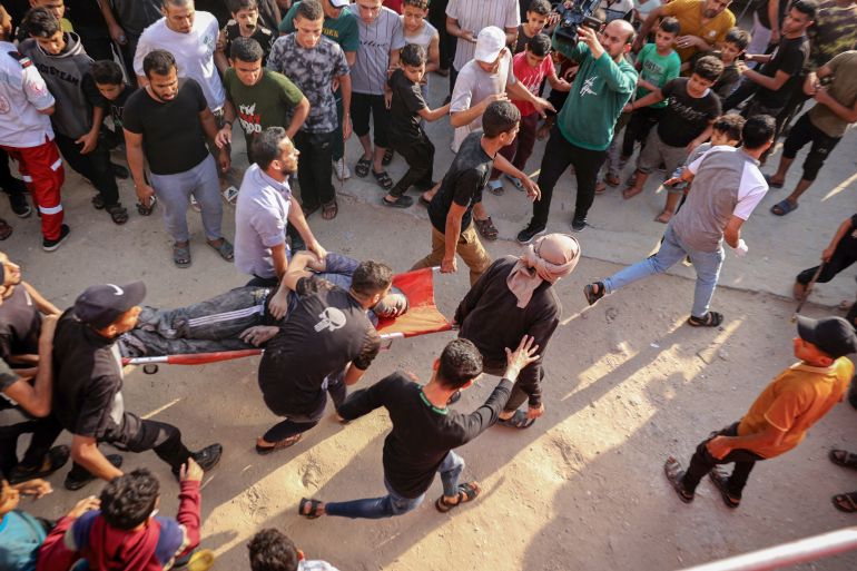 EDITORS NOTE: Graphic content / Palestinians transport an injured man pulled from the rubble of a house destroyed in an Israeli strike in the center of Rafah in the southern Gaza Strip on May 5, 2024, amid the ongoing conflict between Israel and the Palestinian Hamas movement. (Photo by AFP