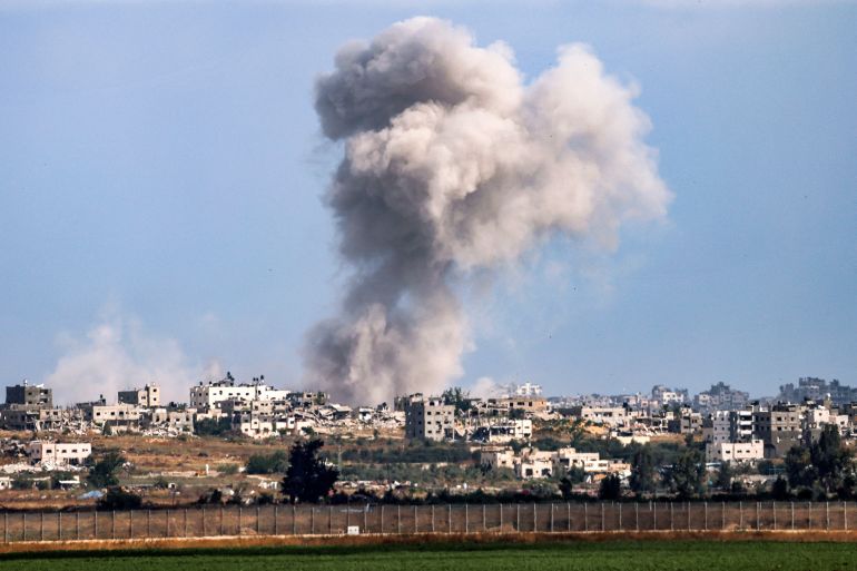 A smoke plume from an explosion billows in the Gaza Strip as seen from a position along Israel's southern border with the Palestinian territory on May 13, 2024 amid the ongoing conflict between Israel and the militant group Hamas. (Photo by JACK GUEZ / AFP