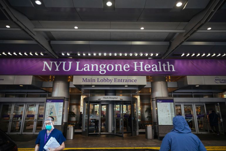 FILE - Health care workers walk in and out of the entrance at NYU-Langone Hospital on Monday, Dec. 14, 2020, in New York. A nurse was fired by the hospital after she referred to Israel's war in Gaza as "genocide" during a speech accepting an award. Labor and delivery nurse Hesen Jabr, who is Palestinian American, was being honored by NYU Langone Health for her compassion in caring for mothers who had lost babies when she drew a link between her work and the suffering of mothers in Gaza. (AP Photo/Kevin Hagen, File)